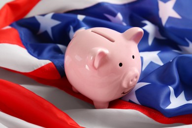 Pink piggy bank on national American flag, closeup