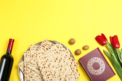 Flat lay composition with matzos on yellow background, space for text. Passover (Pesach) celebration