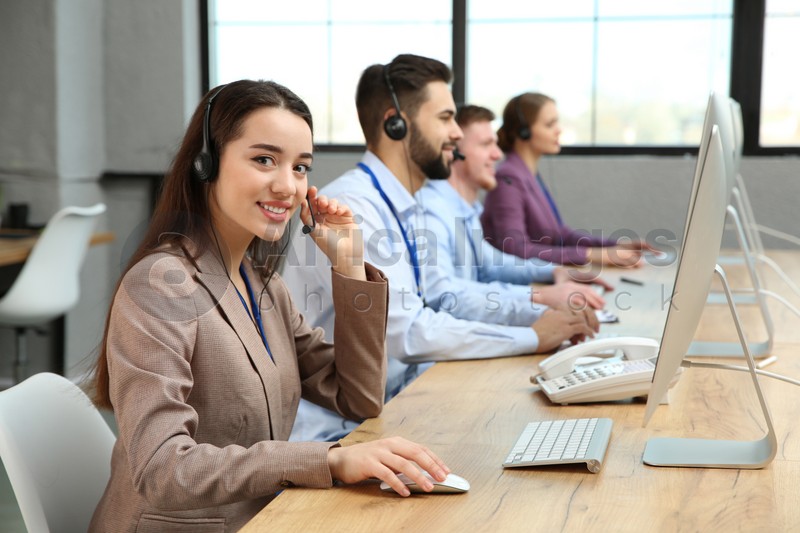 Photo of Technical support operator working with colleagues in office