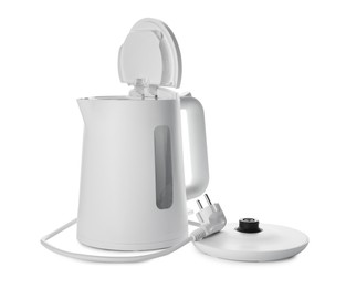 Modern electric kettle with base and plug isolated on white
