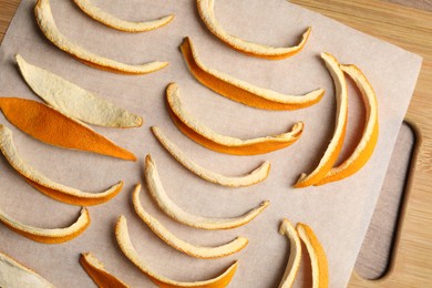 Photo of Many dry orange peels on wooden table, top view