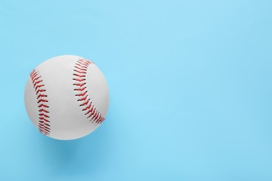 Photo of Baseball ball on light blue background, top view with space for text. Sports game