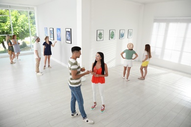 Group of people at exhibition in art gallery