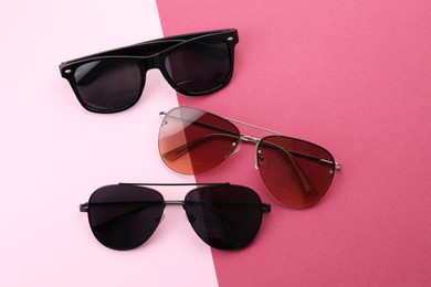 Different stylish sunglasses on color background, flat lay