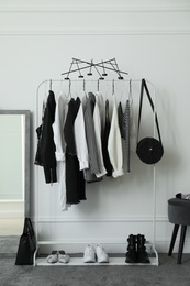 Rack with stylish clothes in modern dressing room