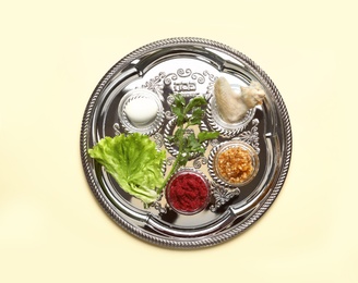 Traditional silver plate with symbolic meal for Passover (Pesach) Seder on color background, top view