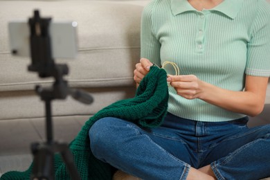 Photo of Teacher conducting online knitting course at home, closeup. Time for hobby