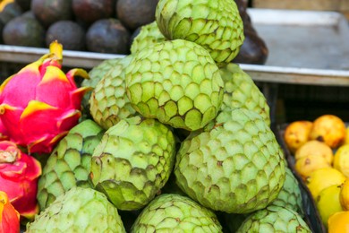 Cherimoya and dragon fruit at market, closeup