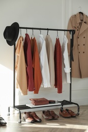 Photo of Rack with stylish clothes indoors. Interior design