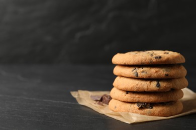 Delicious chocolate chip cookies on black table. Space for text