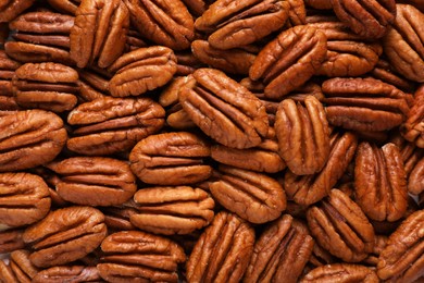 Photo of Tasty fresh ripe pecan nuts as background, top view