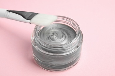 Professional face mask with brush on pink background