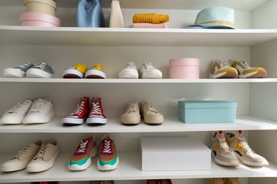 White shelving unit with collection of colorful sneakers and accessories