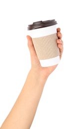 Woman holding takeaway paper coffee cup with cardboard sleeve on white background, closeup
