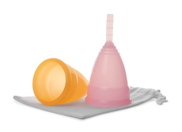 Menstrual cups with cotton bag isolated on white. Reusable feminine hygiene product