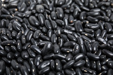 Heap of black beans as background, closeup. Veggie seeds