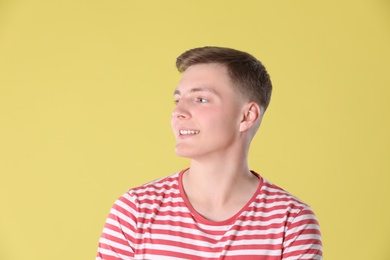 Portrait of teenage boy on yellow background