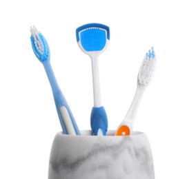 Holder with tongue cleaner and toothbrushes on white background