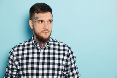 Photo of Handsome hipster man on light blue background. Space for text