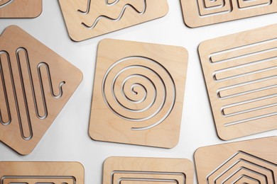 Photo of Wooden finger labyrinths on white background, top view. Montessori toy