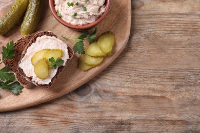 Photo of Sandwich with delicious lard spread and pickles on wooden table, flat lay. Space for text