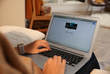 MYKOLAIV, UKRAINE - OCTOBER 31, 2020: Woman using Google search engine on MacBook Air laptop indoors, closeup