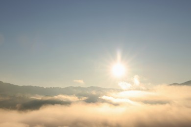 Aerial view of beautiful mountain landscape with thick mist at sunrise