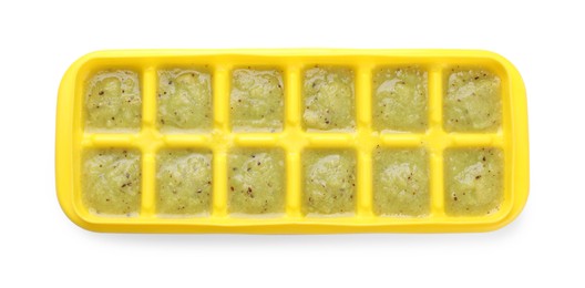 Kiwi puree in ice cube tray isolated on white, top view. Ready for freezing
