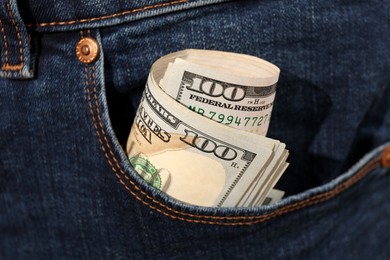 Dollar banknotes in pocket of jeans, closeup. Spending money