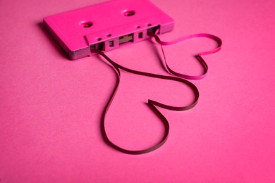 Music cassette and hearts made with tape on pink background. Listening love song