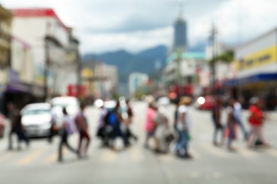 Blurred view of people on crosswalk in city. Bokeh effect