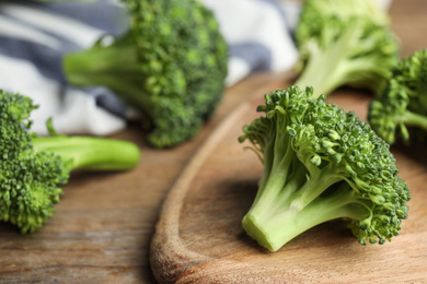 Fresh green broccoli on wooden table, closeup. Organic food