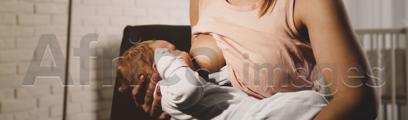 Young woman breast feeding her little baby at home, closeup. Banner design