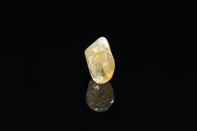 Photo of Beautiful citrine quartz gemstone on black background