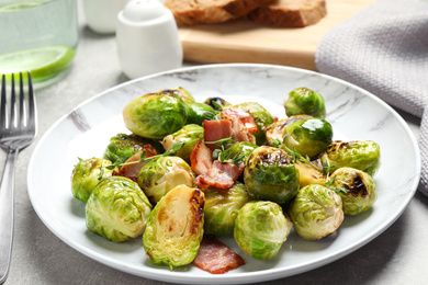 Delicious fried Brussels sprouts with bacon served on table