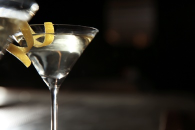 Glass of lemon drop martini cocktail in bar, closeup. Space for text