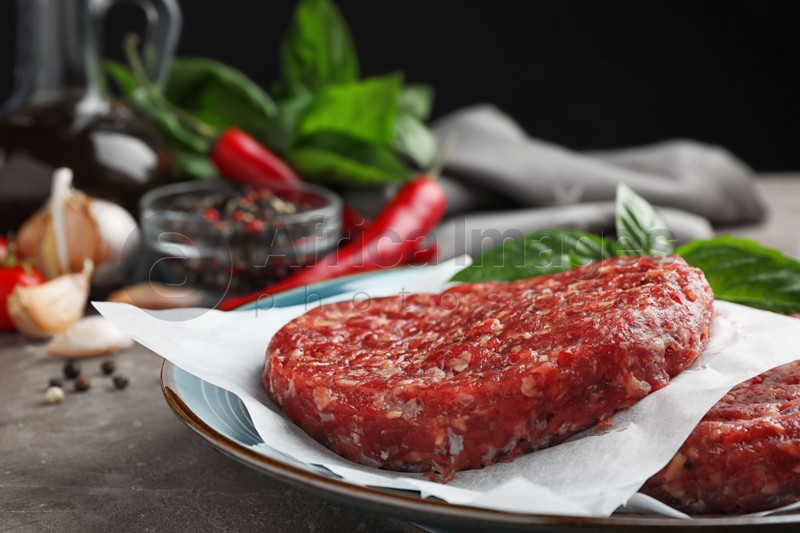 Raw meat cutlets for burger on table, closeup