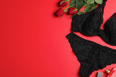 Flat lay composition with sexy lingerie on red background. Space for text
