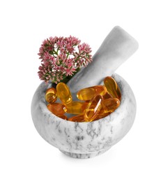 Photo of Mortar with flowers and pills on white background