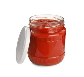 Glass jar of delicious canned lecho and lid on white background