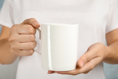 Woman holding ceramic cup, closeup. Mock up for design
