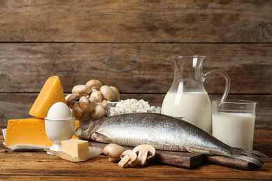 Photo of Fresh products rich in vitamin D on wooden table