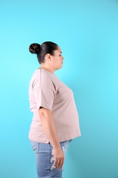 Fat woman on color background. Weight loss