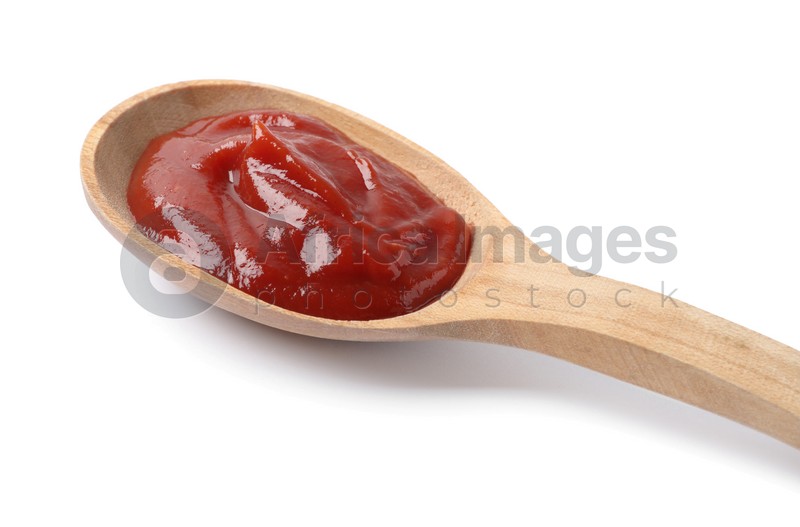 Ketchup in wooden spoon isolated on white, closeup