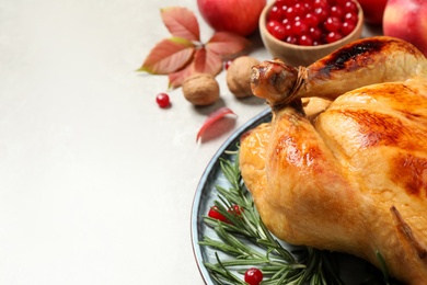 Traditional Thanksgiving day feast with delicious cooked turkey and autumn decor on grey table, closeup. Space for text