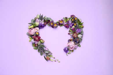 Photo of Beautiful heart made of different flowers on violet background, flat lay. Space for text