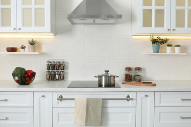 Elegant kitchen interior with modern stove and stylish furniture