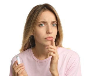 Woman with herpes applying cream onto lip against white background