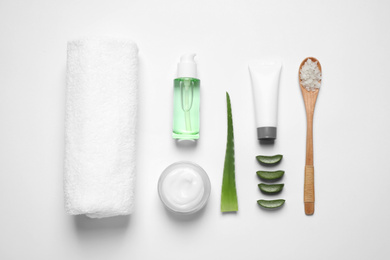 Flat lay composition with aloe vera and cosmetic products on white background