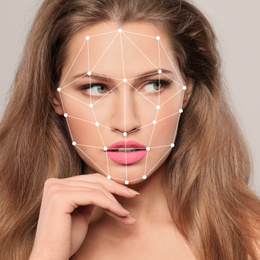 Facial recognition system. Woman with digital biometric grid on light background